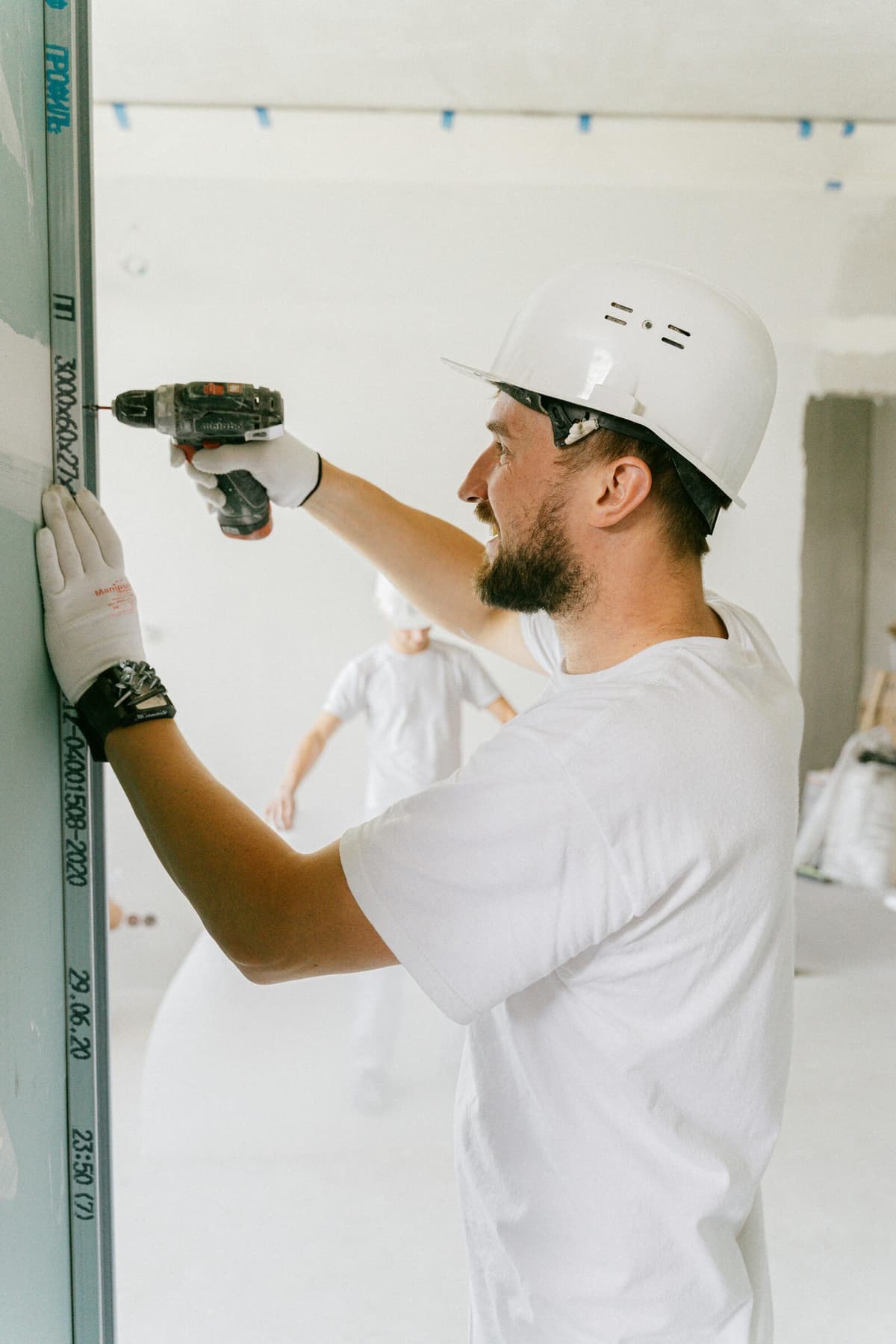 Contractor using a drill during interior work